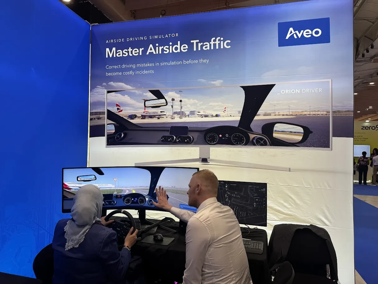 A visitor driving the Aveo Driving Simulator at the Aveo stand, World Aviation Festival, Lisbon
